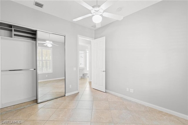 unfurnished bedroom featuring light tile patterned floors, a closet, and ceiling fan