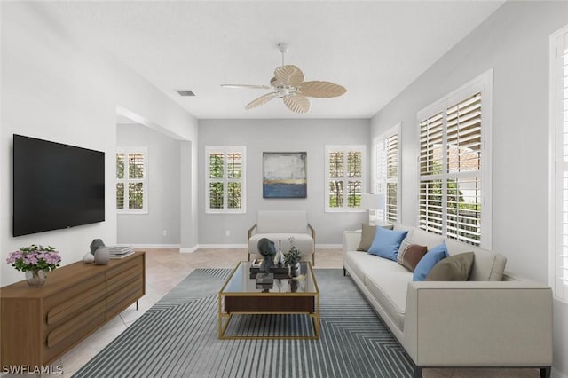 tiled living room featuring ceiling fan