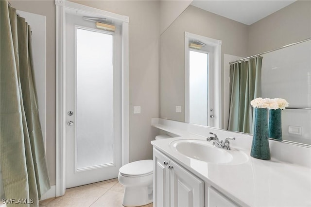 bathroom featuring tile patterned flooring, vanity, toilet, and a shower with curtain