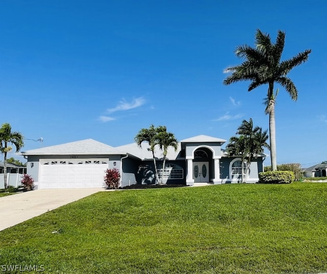 view of front of property with a front yard and a garage