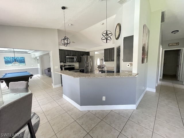 kitchen with pendant lighting, stainless steel appliances, billiards, light stone countertops, and high vaulted ceiling