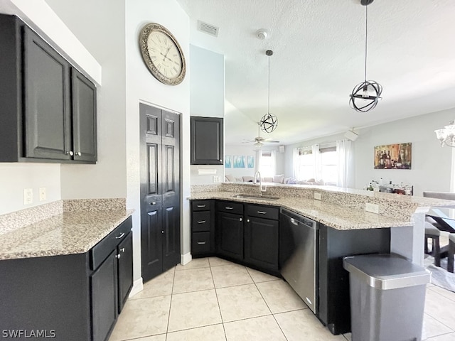 kitchen with ceiling fan with notable chandelier, light tile flooring, sink, stainless steel dishwasher, and pendant lighting