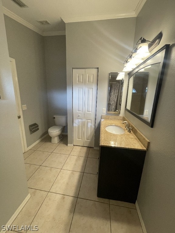 bathroom featuring tile floors, large vanity, toilet, and ornamental molding