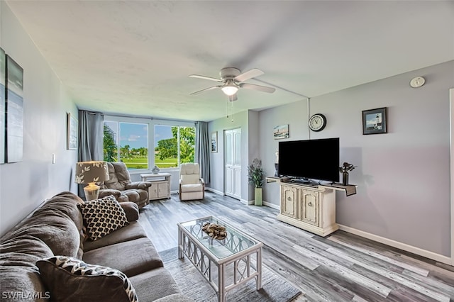 living room featuring ceiling fan and light hardwood / wood-style flooring