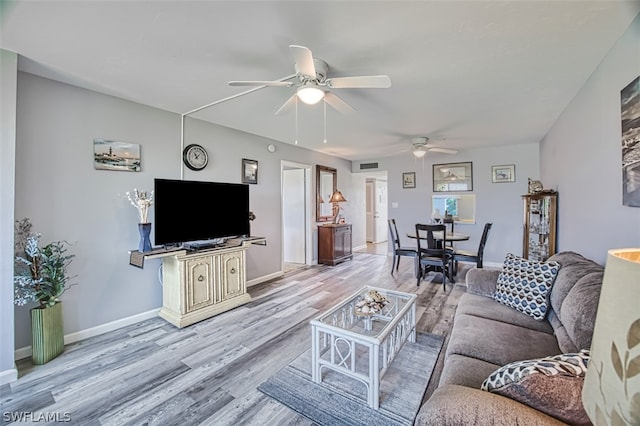 living room featuring ceiling fan and wood-type flooring