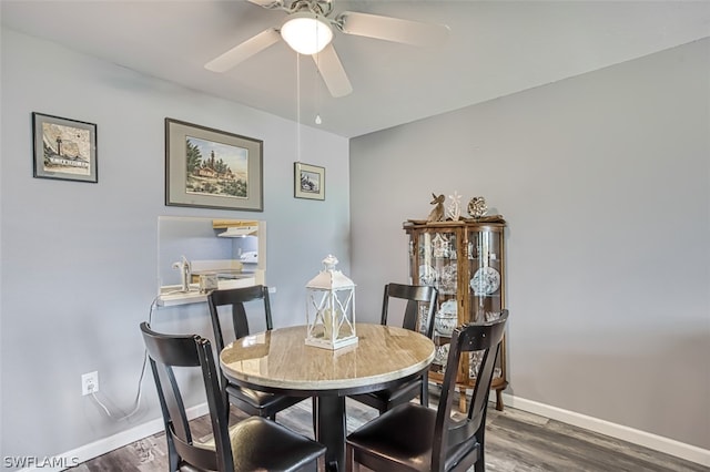 dining area with ceiling fan and dark hardwood / wood-style flooring