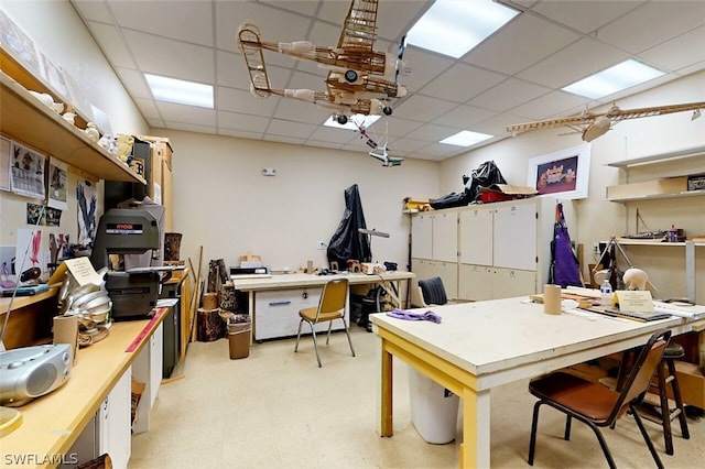 office space featuring a workshop area and a drop ceiling