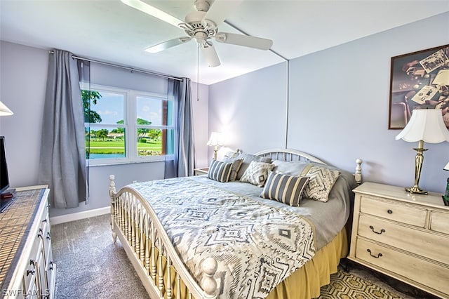 bedroom featuring ceiling fan and dark carpet