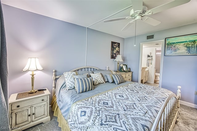 bedroom featuring ceiling fan, ensuite bathroom, and light carpet