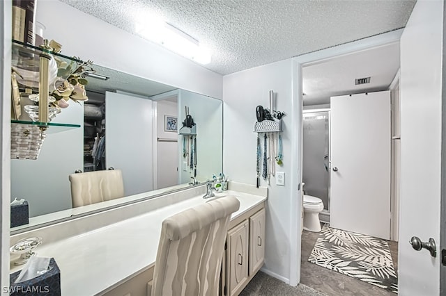 bathroom featuring walk in shower, vanity, a textured ceiling, and toilet