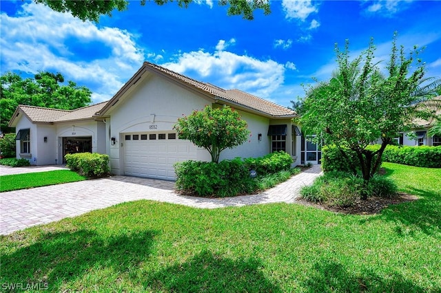 view of front of property featuring a garage and a front lawn