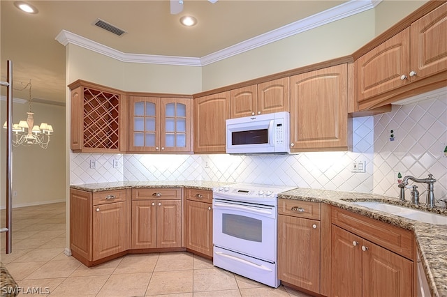 kitchen featuring white appliances, sink, ornamental molding, light stone counters, and light tile patterned floors