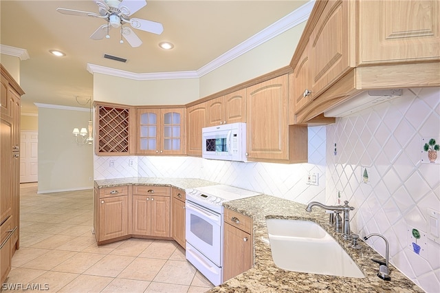 kitchen featuring sink, white appliances, light stone countertops, and crown molding