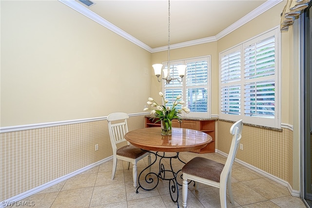 dining room with light tile patterned floors, ornamental molding, and an inviting chandelier