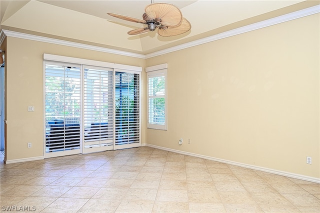 tiled empty room featuring ceiling fan, crown molding, and a raised ceiling