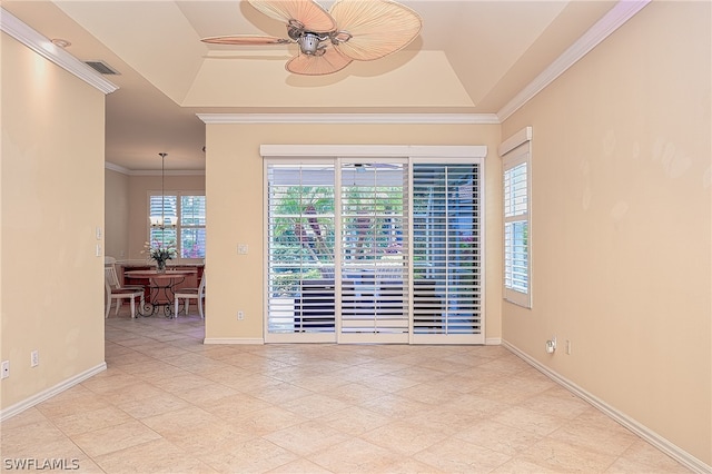 unfurnished room featuring ceiling fan, a tray ceiling, and ornamental molding