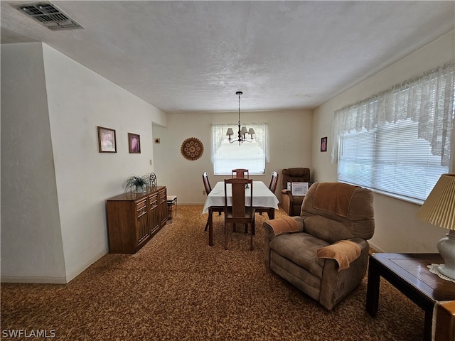 interior space featuring a notable chandelier, a textured ceiling, and plenty of natural light