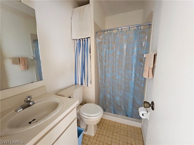 bathroom featuring toilet, tile floors, and vanity