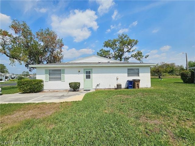 exterior space with a yard and central AC