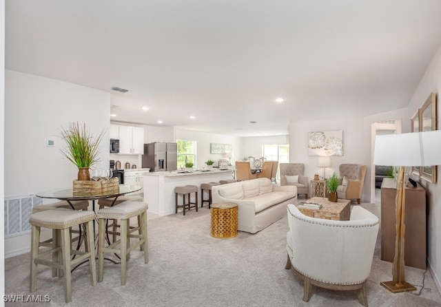 living room featuring light carpet