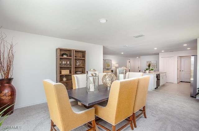 dining room featuring light colored carpet