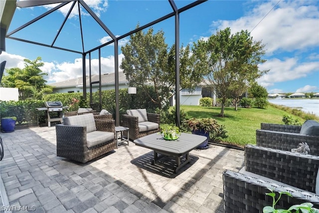 view of patio / terrace featuring a water view, a lanai, and outdoor lounge area