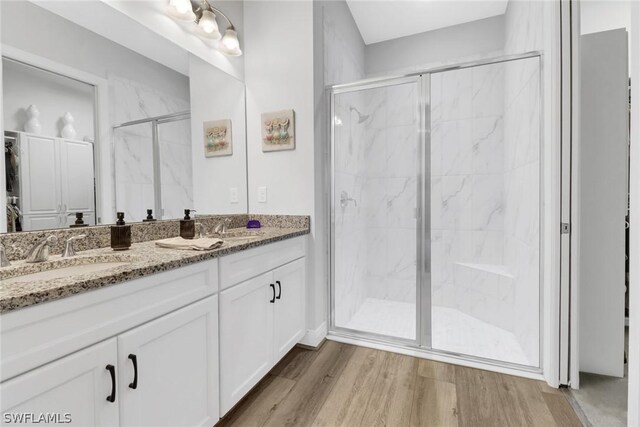 bathroom with vanity, hardwood / wood-style floors, and walk in shower