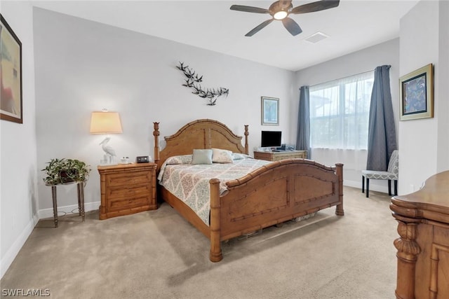 bedroom featuring light carpet and ceiling fan