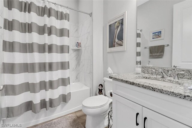 full bathroom with vanity, toilet, and shower / bath combo with shower curtain