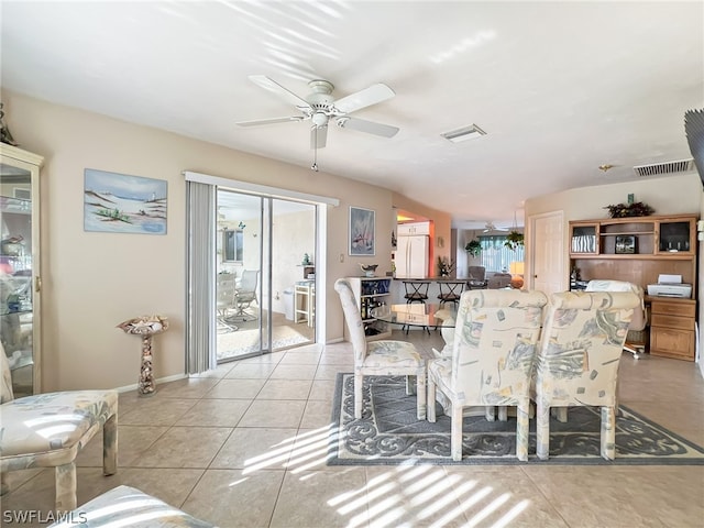 tiled dining space with ceiling fan