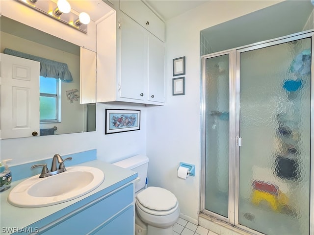 bathroom with an enclosed shower, vanity, tile floors, and toilet