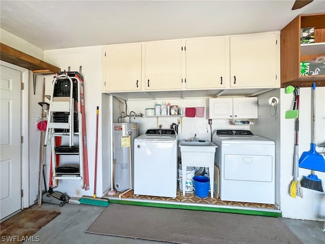 laundry area featuring cabinets, washing machine and clothes dryer, and electric water heater