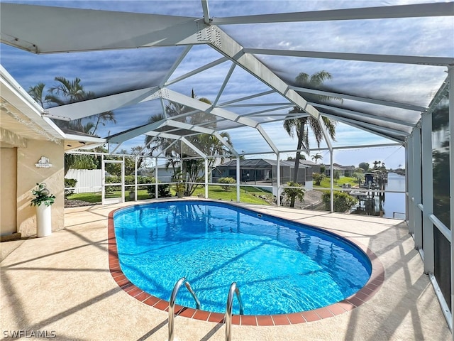 view of swimming pool with a patio area and glass enclosure