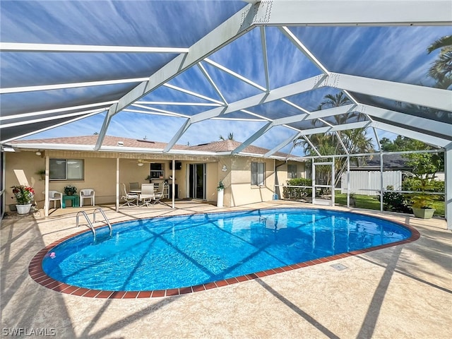 view of pool with a patio area, a lanai, and an outdoor structure