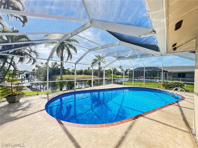 view of swimming pool with a patio and glass enclosure