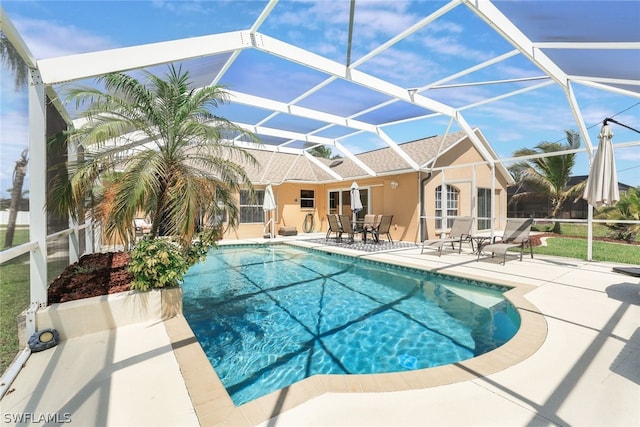 view of pool featuring a patio and glass enclosure