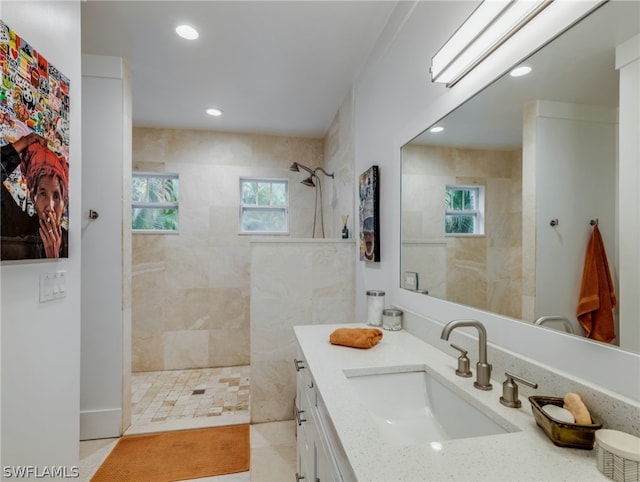 bathroom featuring vanity and a tile shower