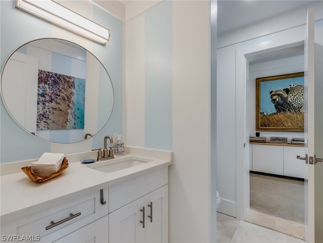 bathroom featuring toilet, tile floors, and large vanity