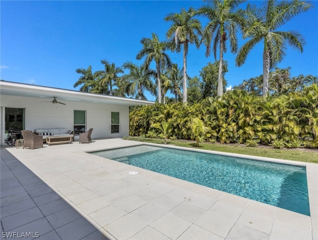 view of swimming pool with ceiling fan and a patio