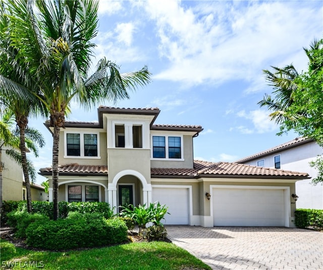 mediterranean / spanish home featuring a garage