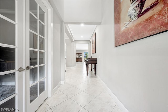 hallway with light tile floors and french doors