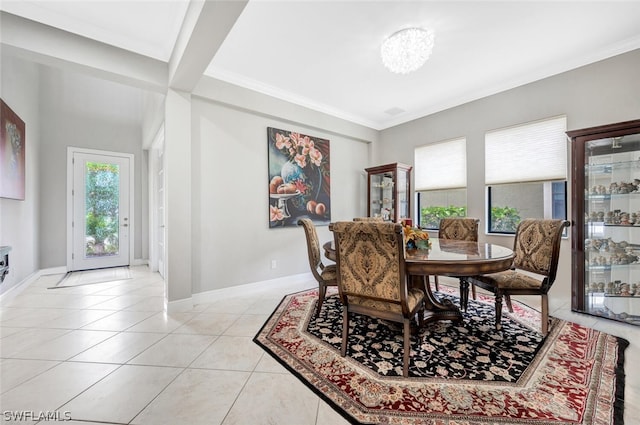 tiled dining area featuring a chandelier and ornamental molding