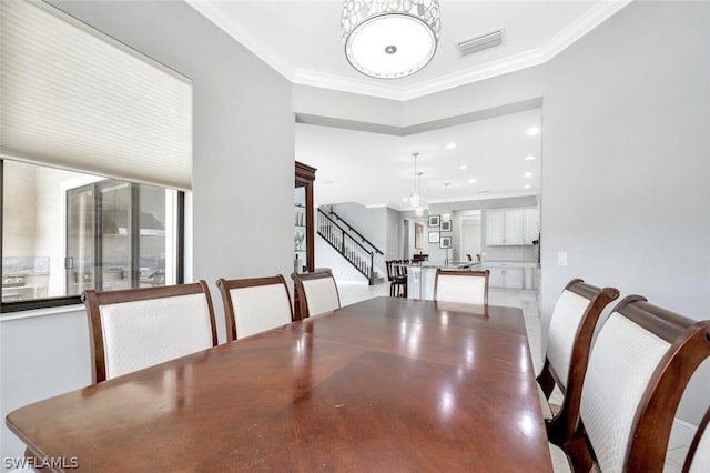 dining area featuring an inviting chandelier and ornamental molding