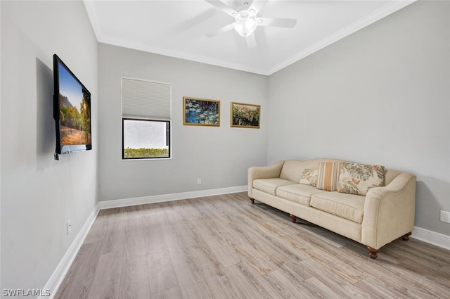 living room with crown molding, ceiling fan, and light wood-type flooring