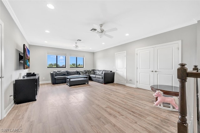 living room featuring ornamental molding, ceiling fan, and light wood-type flooring