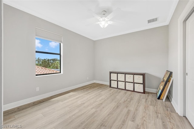 spare room featuring light hardwood / wood-style floors, ceiling fan, and crown molding