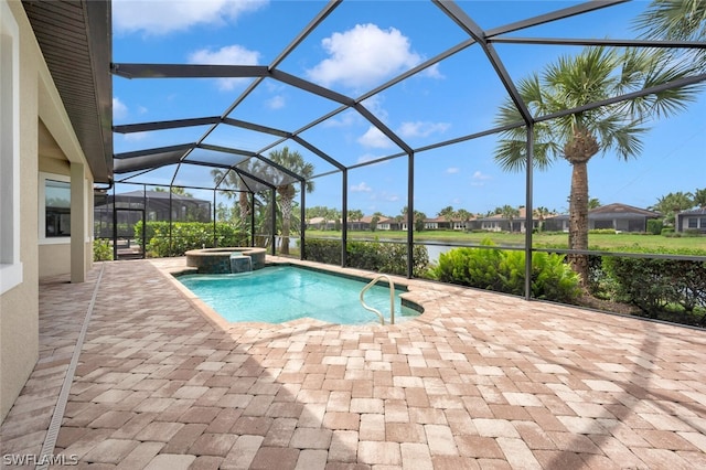 view of pool with a patio area, an in ground hot tub, and glass enclosure