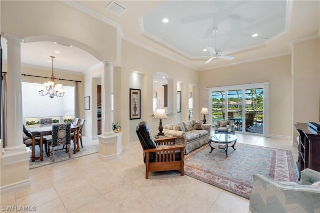 living room with crown molding, light tile patterned floors, ceiling fan with notable chandelier, and ornate columns