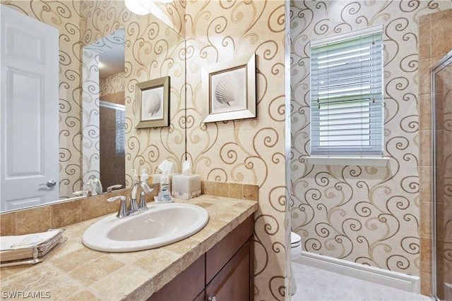 bathroom with vanity, walk in shower, and toilet