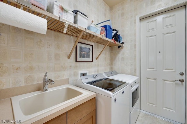 washroom with washer and clothes dryer and sink